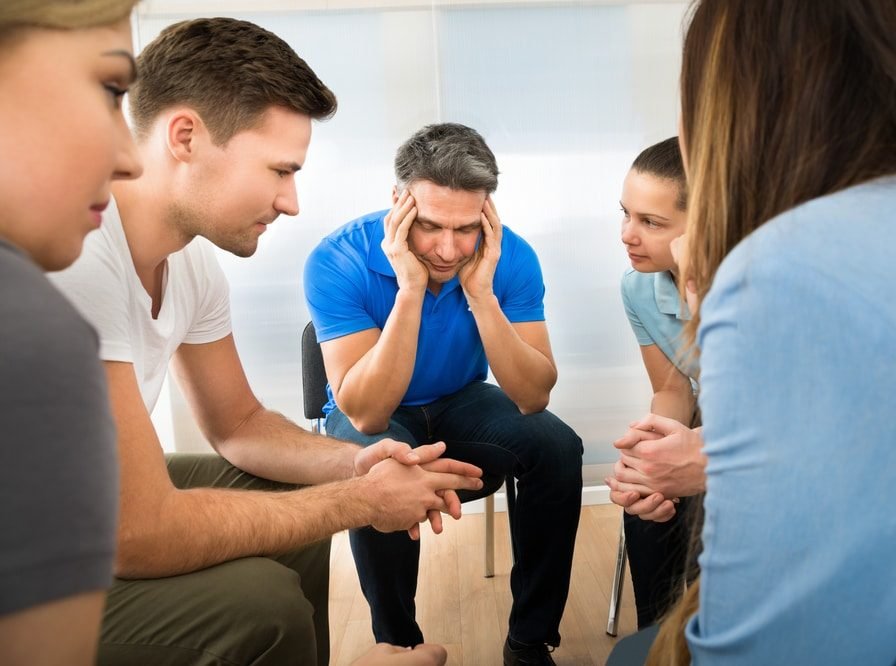 Depressed Man Sitting With His Peers