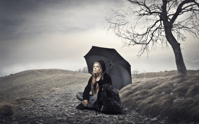 woman sitting in the rain, depressed female